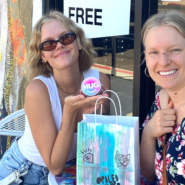 2 jars vegan cakes outside adams ave store.