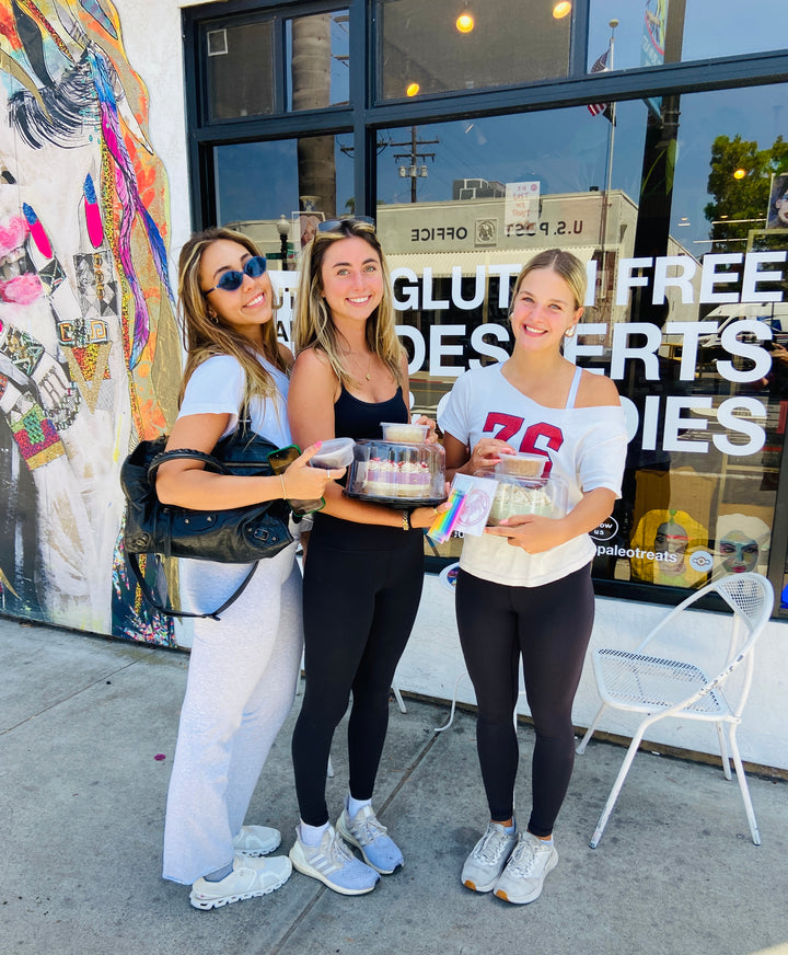 3 smiling women customers outside of the paleo treats store with paleo macaroons.
