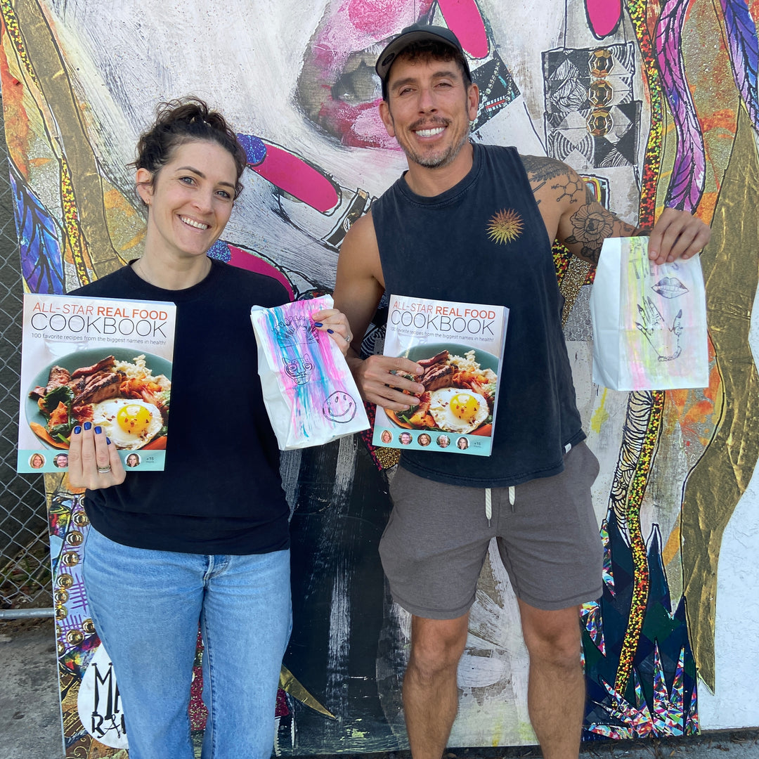Ascb smiling couple with all star real food cookbook in san diego.
