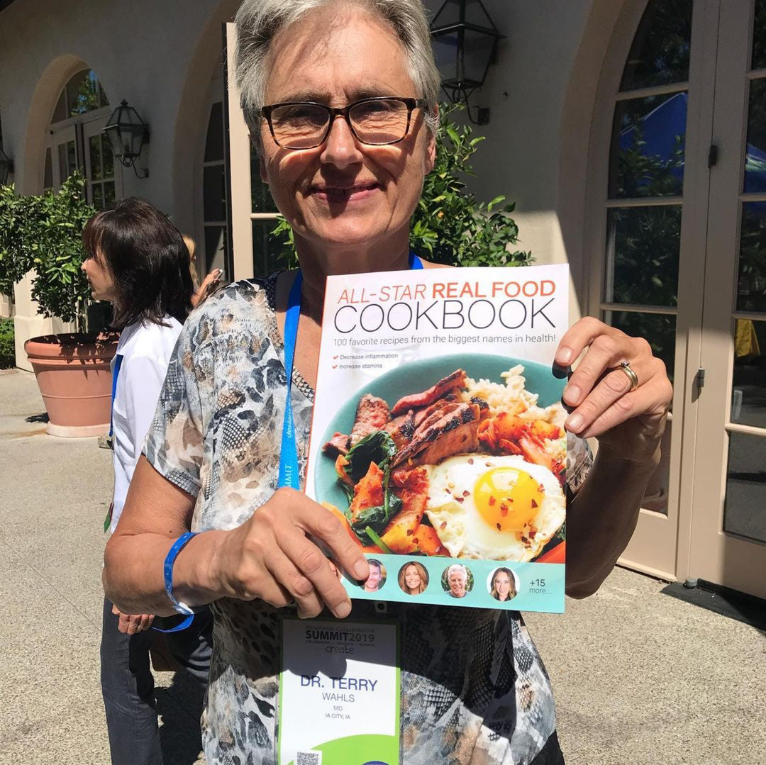 Ascb terry wahls holds up all star real food cookbook by Paleo Treats.