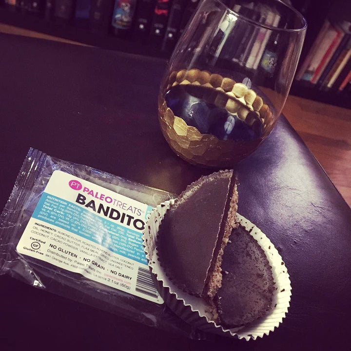 Bandito split and stacked bandito almond butter cup on dining table with glass of wine by Paleo Treats.