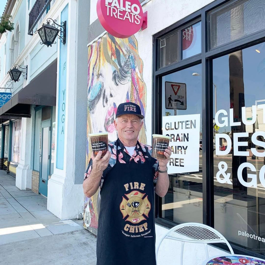 Bone broth holding 2 jars of the best bone broth in san diego outside normal heights store.
