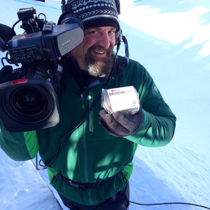 Brownie bomb cameraman on set holds gf brownie snack.