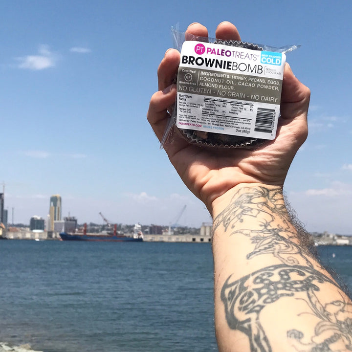 Brownie bomb man holds brownie bomb above san diego bay.