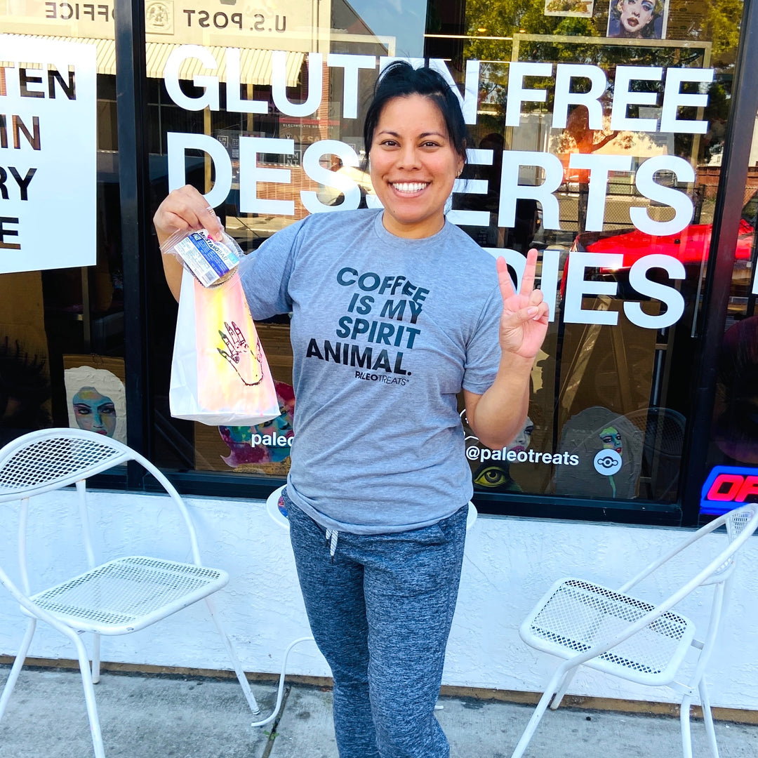 Coffee is my spirit animal woman holding sampler box outside san diego store.