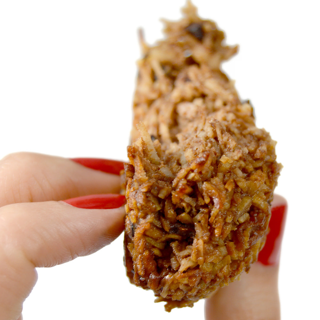 Holding up a paleo macaroon you dont need to make.