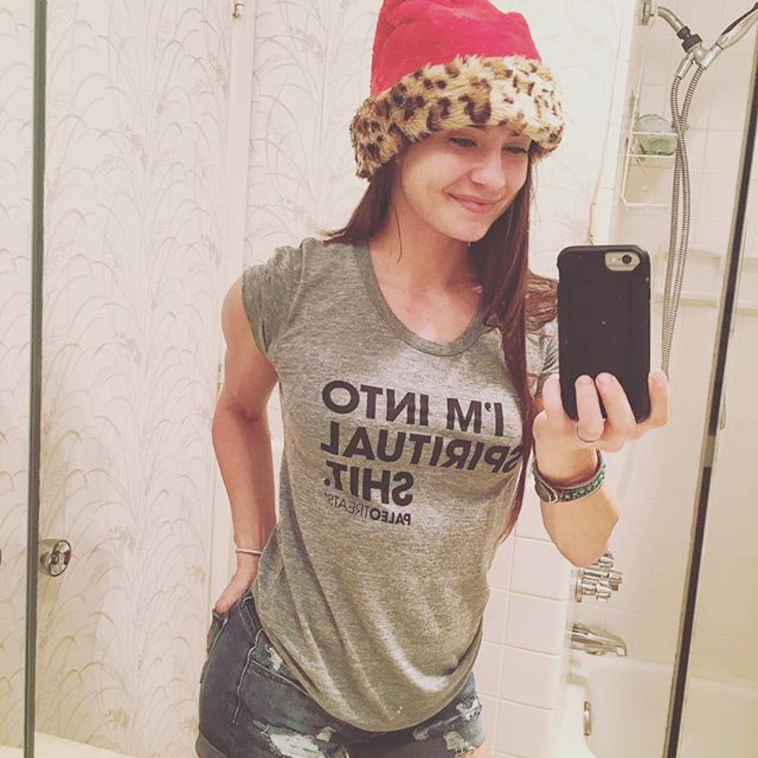 Lady with a santa hat wearing spiritual shit tee.