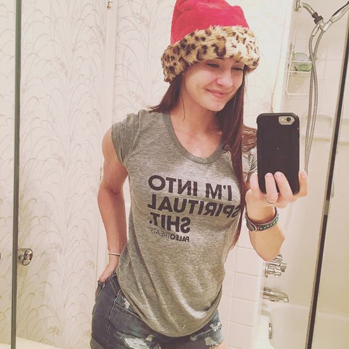 Lady with a santa hat wearing spiritual shit tee.