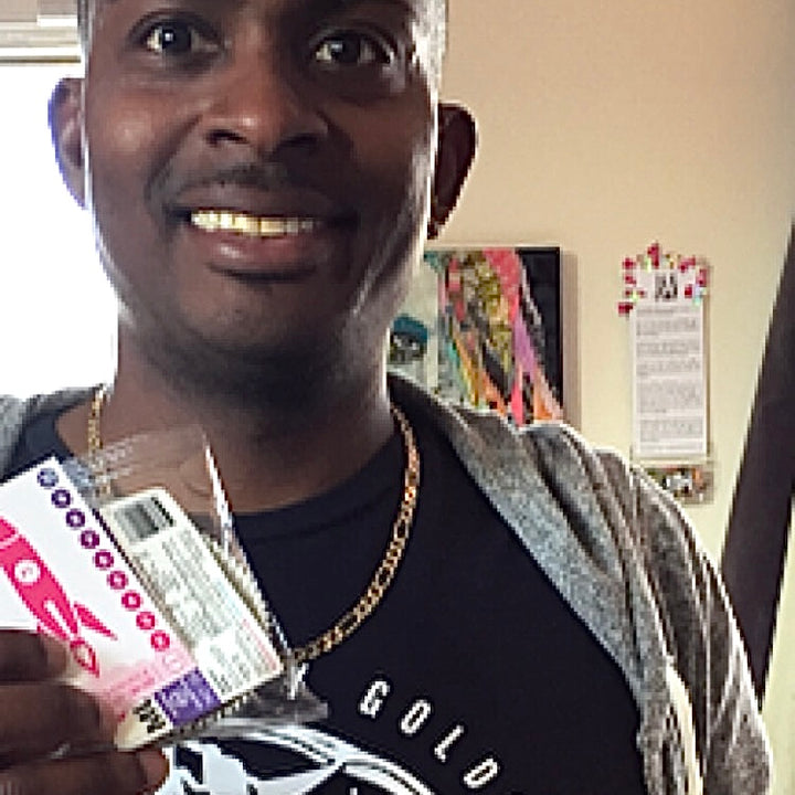 Mustang happy male customer holds up grain free granola bar in san diego store.