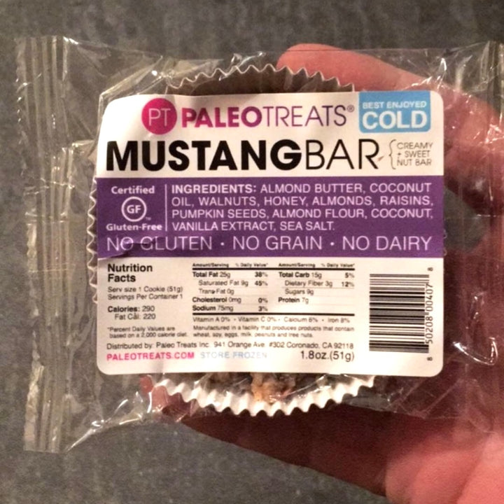 Mustang held in hand pre packaged paleo dessert bar by Paleo Treats.