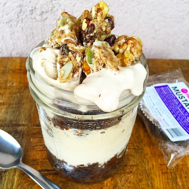 Paleo granola with dairy free yogurt and mustang bar in background by Paleo Treats.