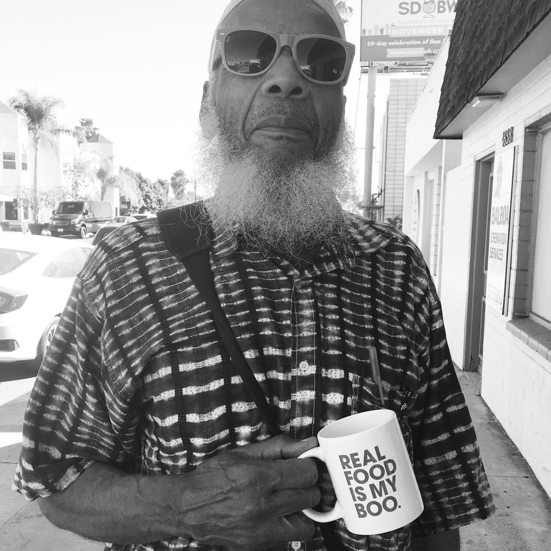 Protein keto donut man enjoying coffee and protein donuts for sale.
