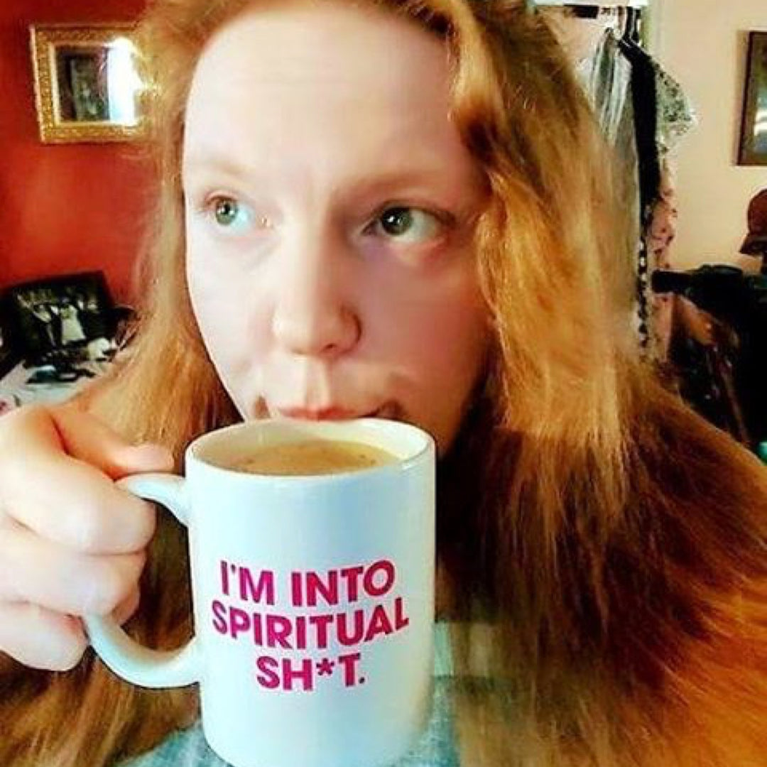 Protein keto donut woman drinking from coffee mug.