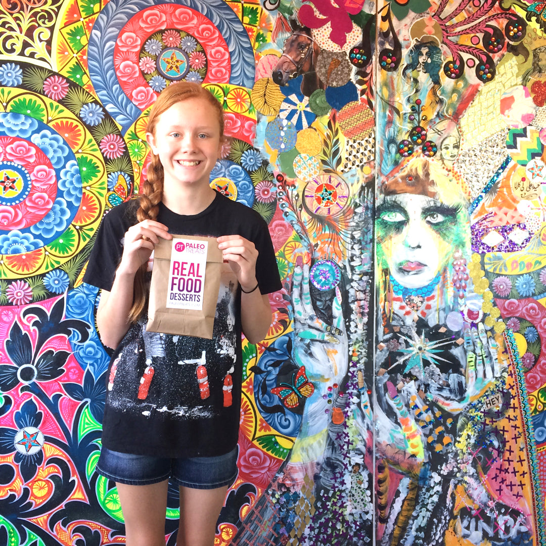 Protein keto donuts young woman with bag of donuts she just bought at our san diego store.