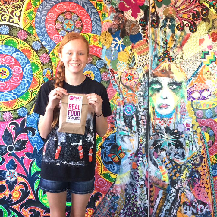 Protein keto donuts young woman with bag of donuts she just bought at our san diego store.