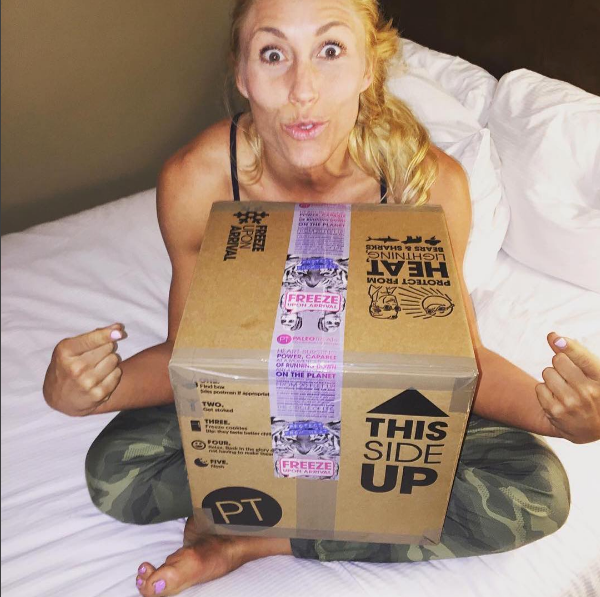 Psyched lady on a grip of paleo treats just delivered.
