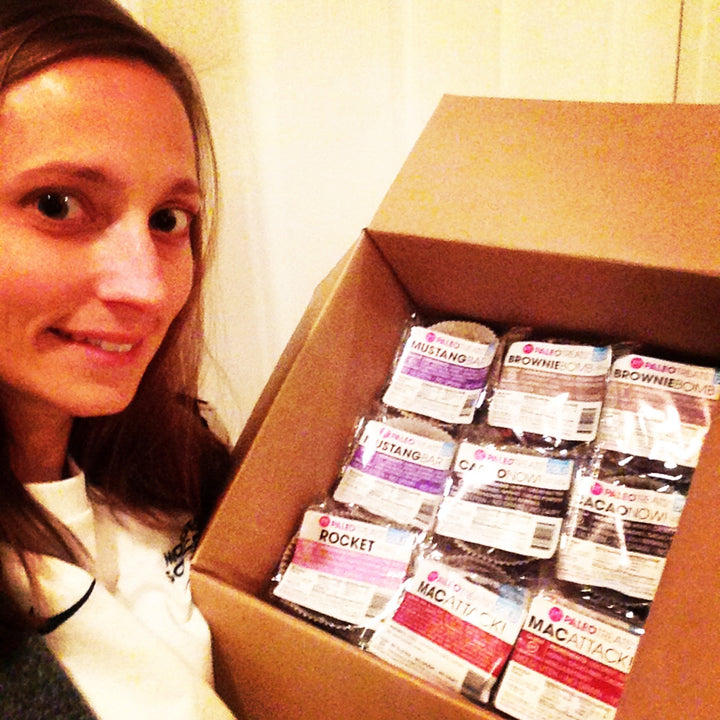 Small stack sampler happy woman opens box of paleo treats just arrived.
