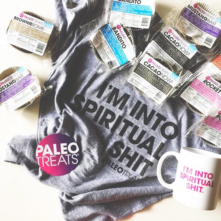 Spiritual shirt shirt surrounded by paleo treats mugs and stickers.