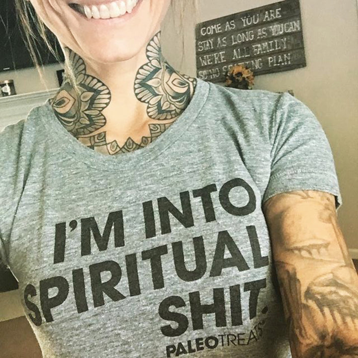 Tattooed woman wears spiritual shit t shirt.