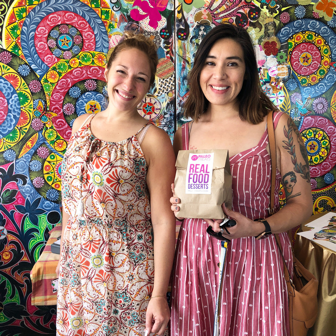 Two smiling women happy to have vegan cakes in a jar.