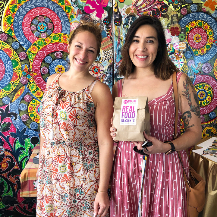 Two smiling women happy to have vegan cakes in a jar.