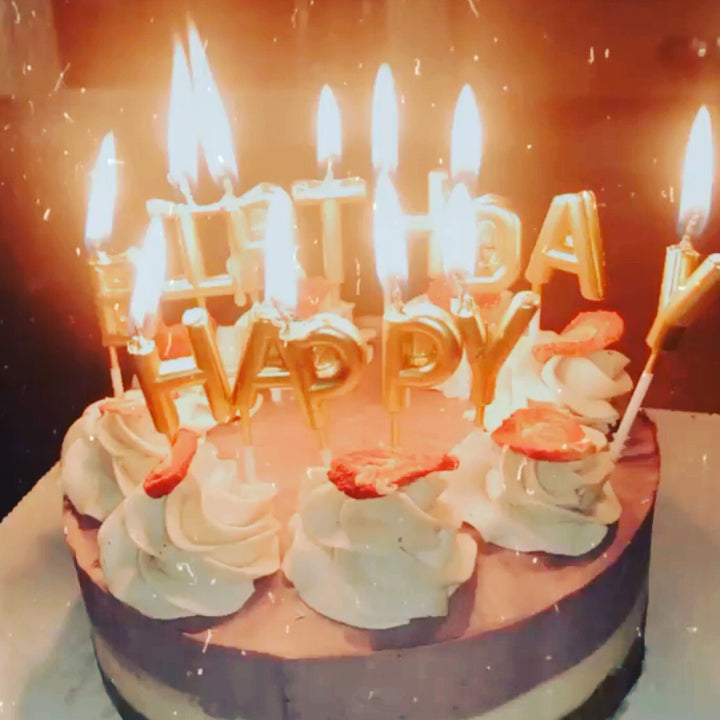 Vegan gf cake birthday candles burning brightly by Paleo Treats.