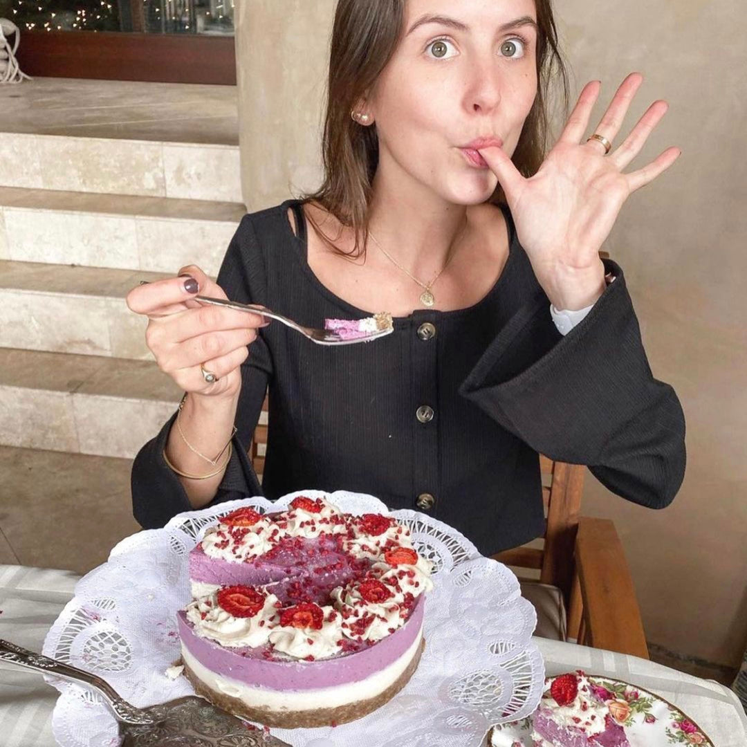 Vegan gf cake woman licking fingers eating gluten free birthday cake.