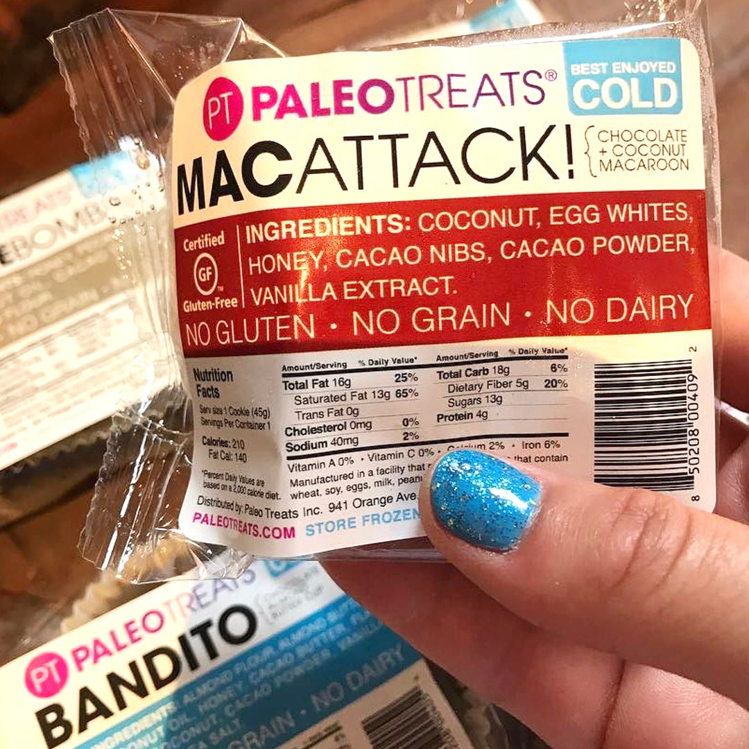 Womans hand holding a paleo macaroon.