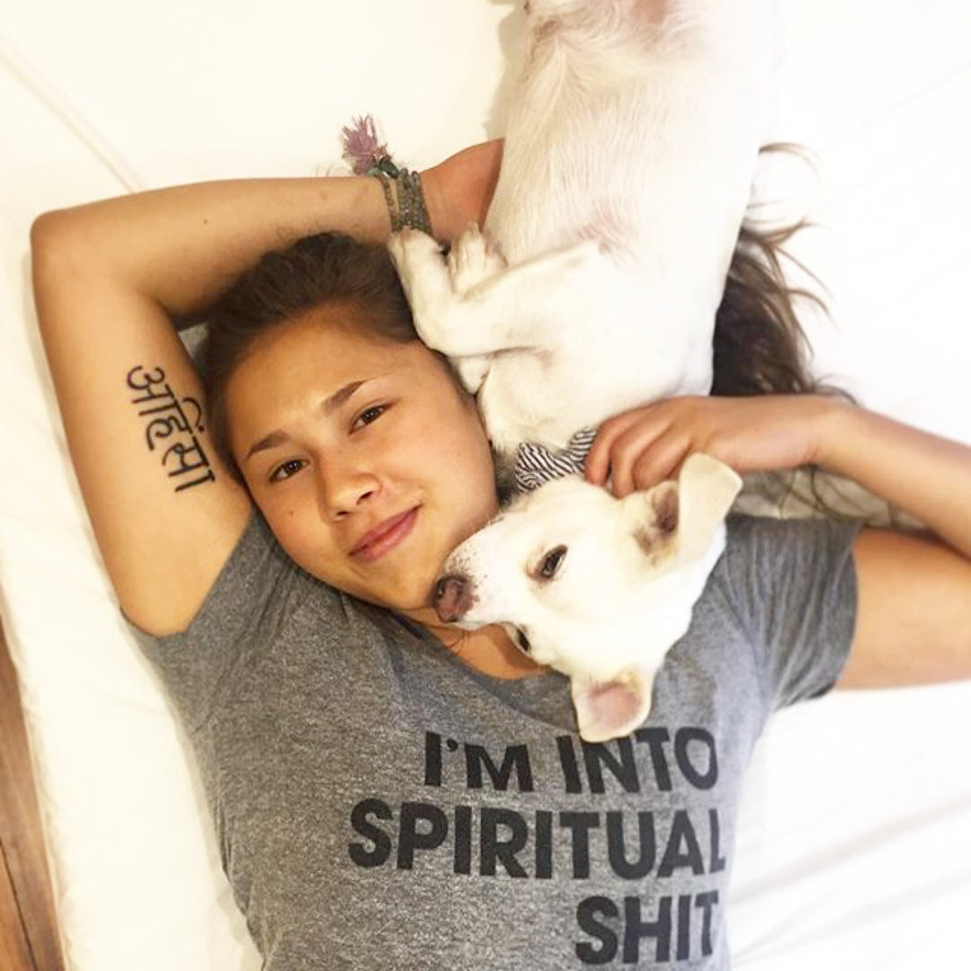 Women laying down with spiritual shit t shirt.