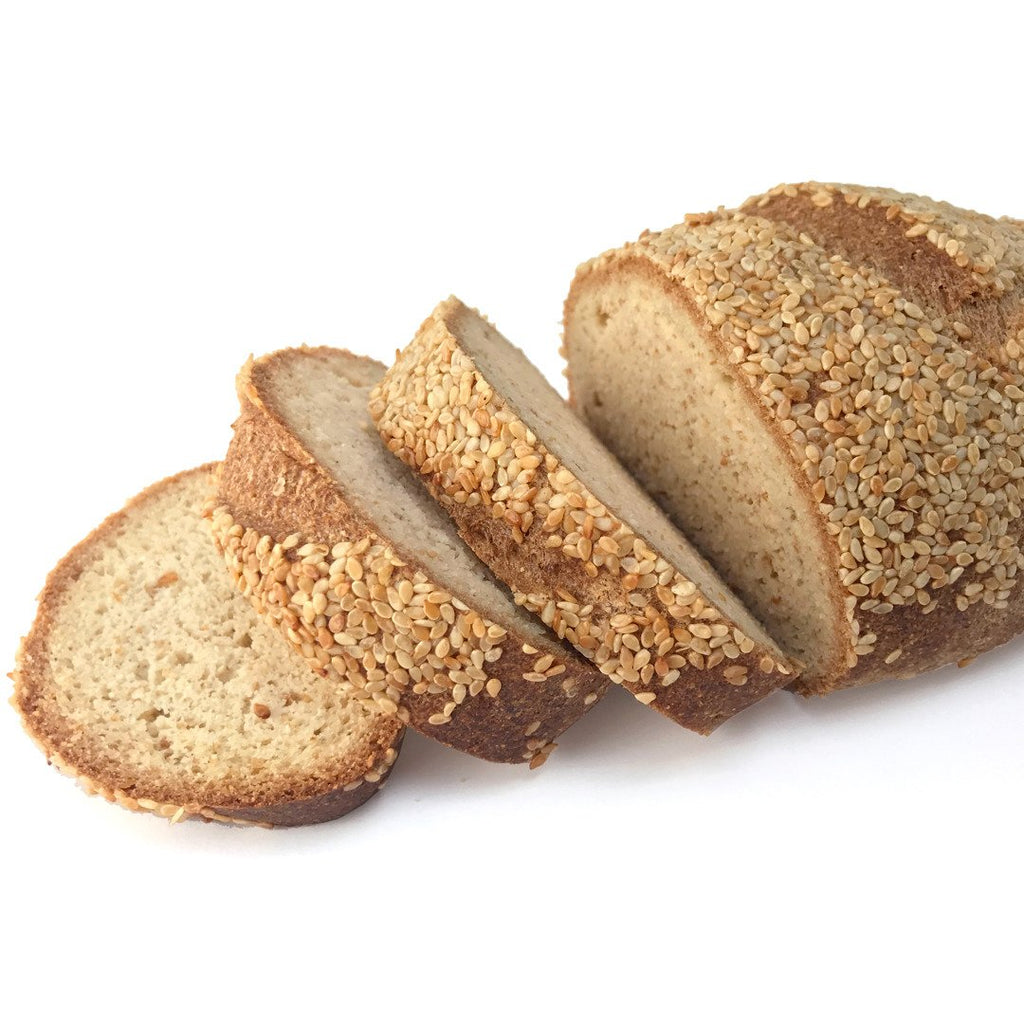 A sliced loaf of sesame keto bread.